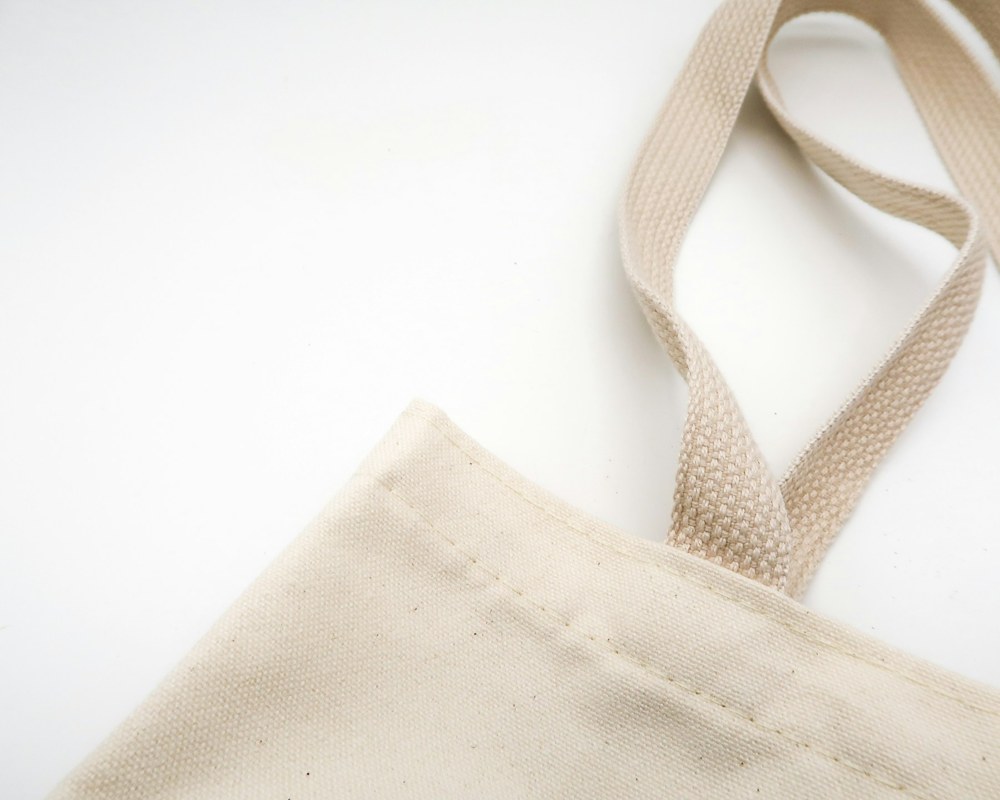 Close-up of natural canvas and handles on a tote bag in the fictional example store